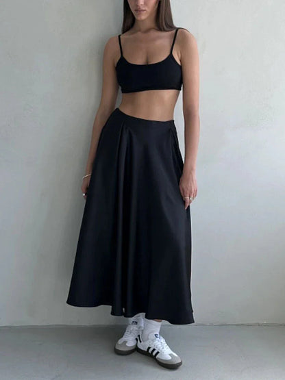 Elegant high-waisted satin maxi skirt in black for women, showcasing a flowing, sophisticated silhouette.
