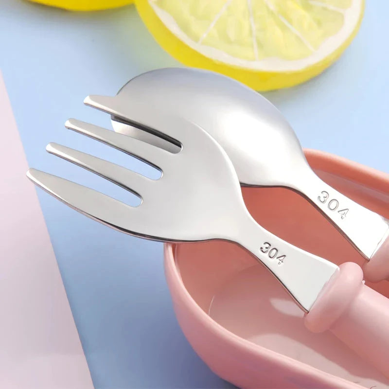 Charming cartoon-designed stainless steel toddler cutlery set with spoon and fork, perfect for mealtimes and self-feeding