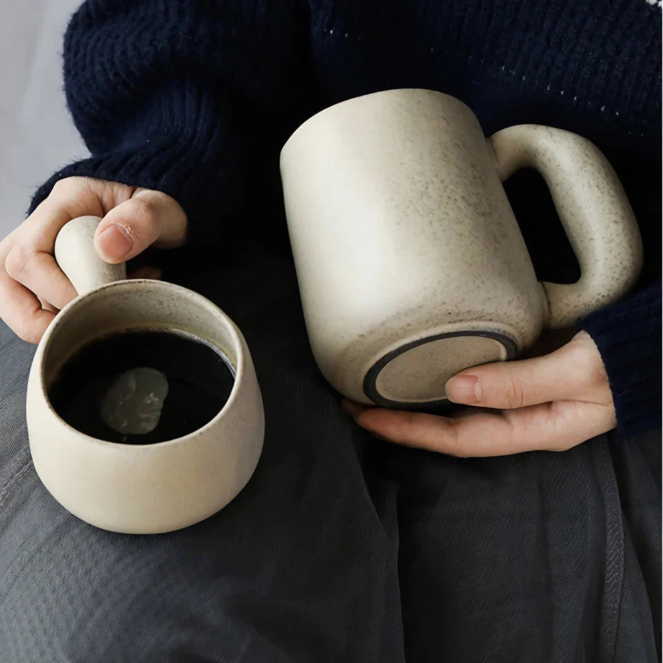 Handcrafted Japanese stoneware retro coffee mug in apricot and grey colors with a comfortable grip and minimalist design