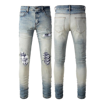 American High Street fashionable men's ripped black and white patch jeans in a light blue denim color