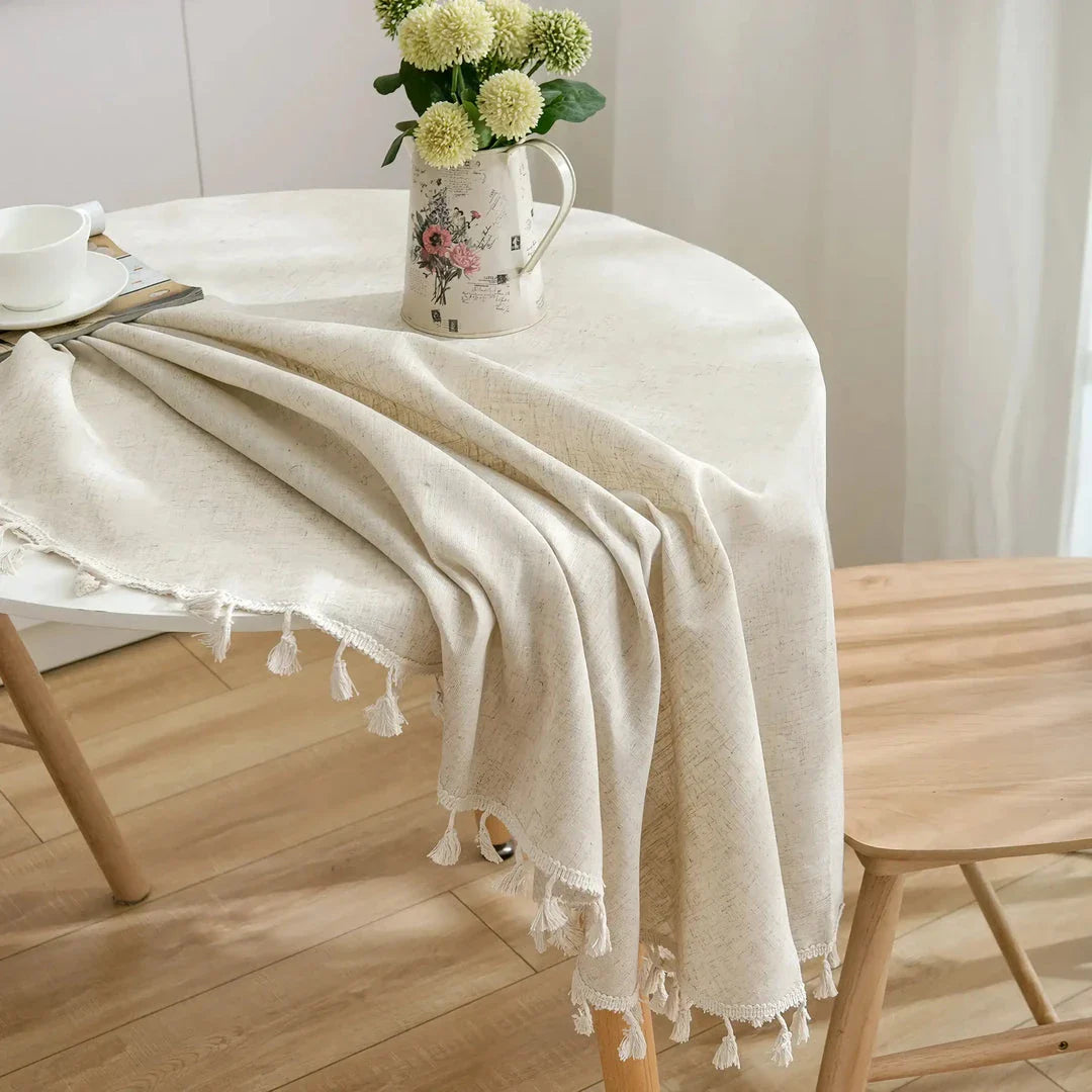 Sophisticated cotton-linen blend round tablecloth with elegant tassels, available in multiple sizes for versatile dining settings