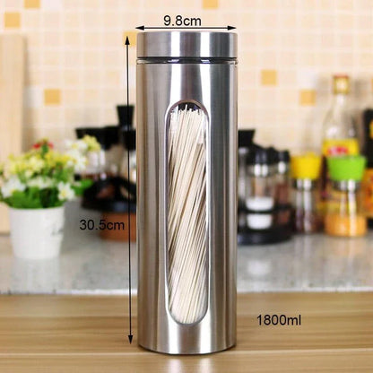 Stainless steel and glass spice jars in various sizes with airtight lids, perfect for organizing and preserving spices in a modern kitchen.