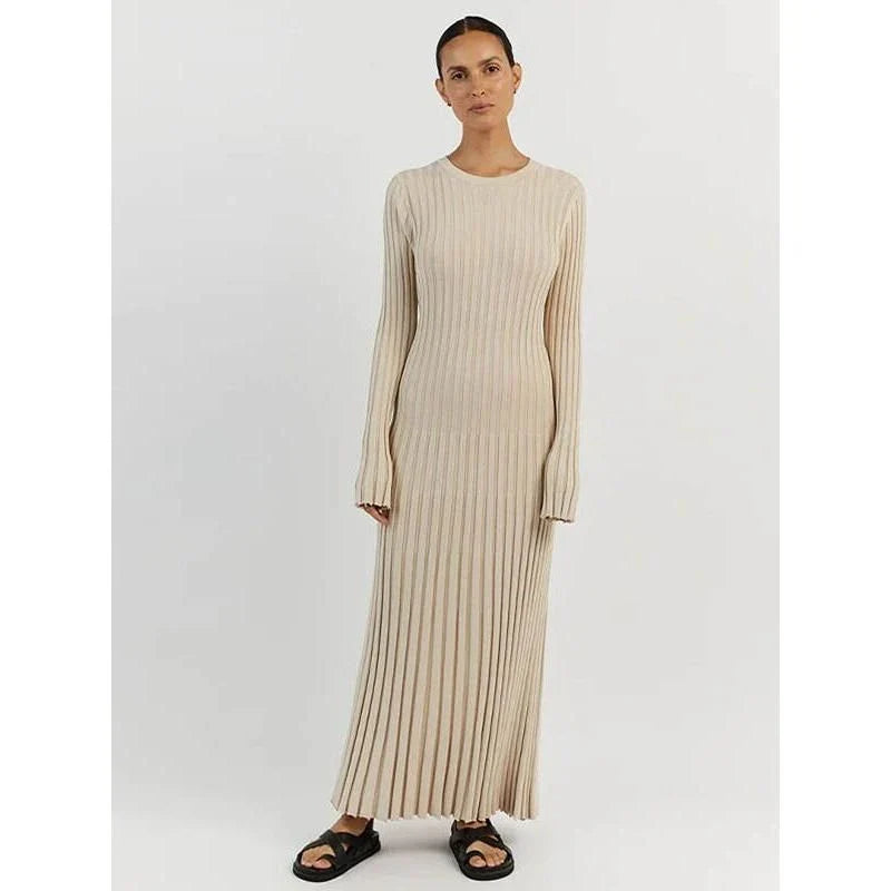 Timeless elegant pleated knit dress in black, perfect for summer office wear with a sophisticated and comfortable design.