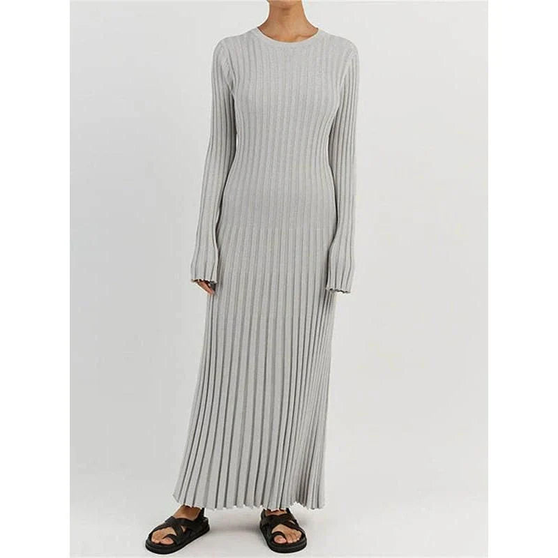 Timeless elegant pleated knit dress in black, perfect for summer office wear with a sophisticated and comfortable design.