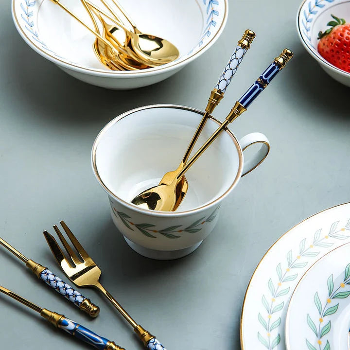 Elegant vintage gold and ceramic coffee and dessert utensil set with hand-painted handles in pink and blue tones