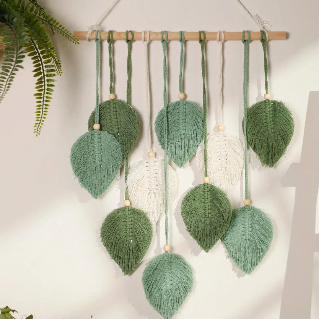Boho macrame leaf tapestry in earthy tones, featuring elegant leaves and flowing tassels for a cozy, nature-inspired decor piece