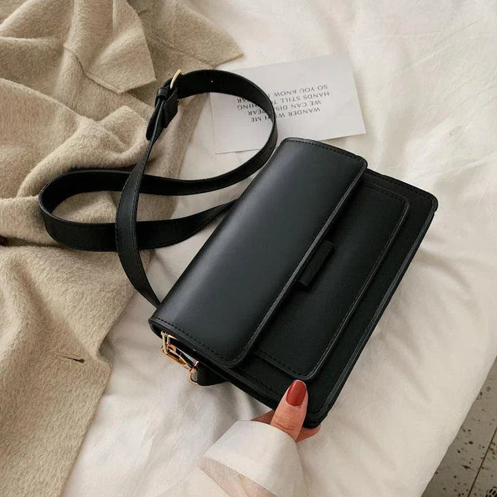 Stylish black crossbody shoulder bag with adjustable strap and multiple interior compartments for modern women