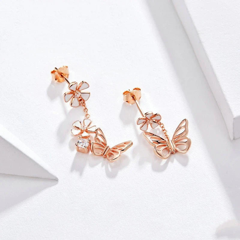 Elegant silver earrings featuring a delicate butterfly design with shimmering white crystals