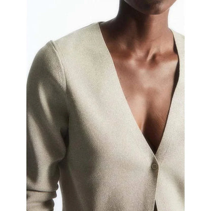 A cozy and chic v-neck cardigan in a classic solid color, featuring a slim, flattering fit and elegant button detailing for versatile autumn and winter wear.
