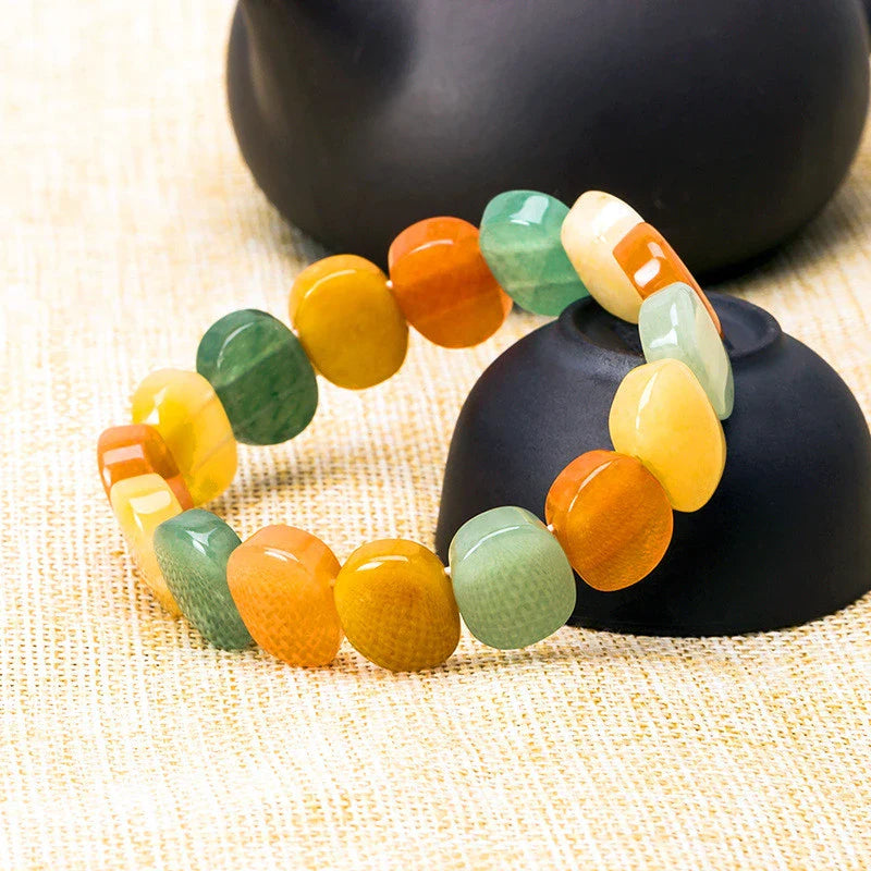Closeup of a natural tiger eye crystal bracelet with a geometric design, showcasing its unique and calming beauty.
