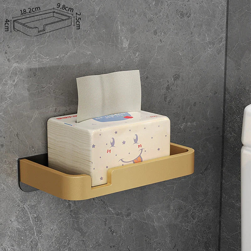 Black and gold aluminum bathroom paper holder with a convenient phone shelf, a stylish and functional accessory for modern bathrooms.