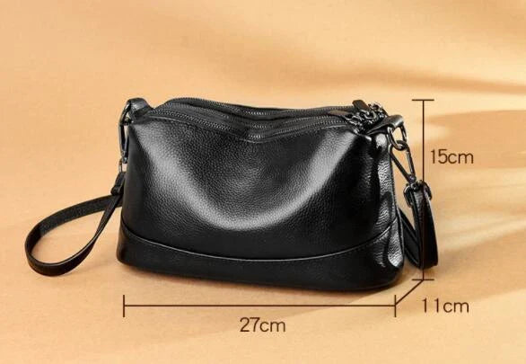 Cowhide shoulder bag in various colors, featuring a sleek and modern design with multiple internal pockets for organization.