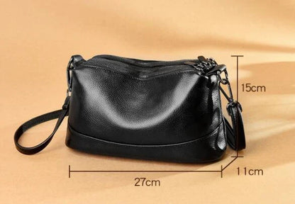 Cowhide shoulder bag in various colors, featuring a sleek and modern design with multiple internal pockets for organization.