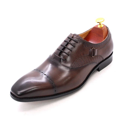 Premium handcrafted leather oxfords in brown with a pointed toe design, suitable for business and formal occasions.