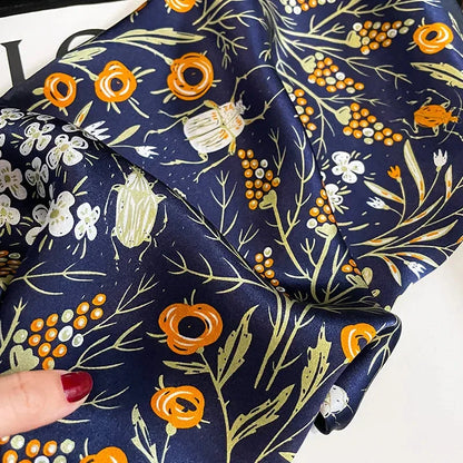 Floral print silk scarf in navy color, a versatile accessory for effortless style