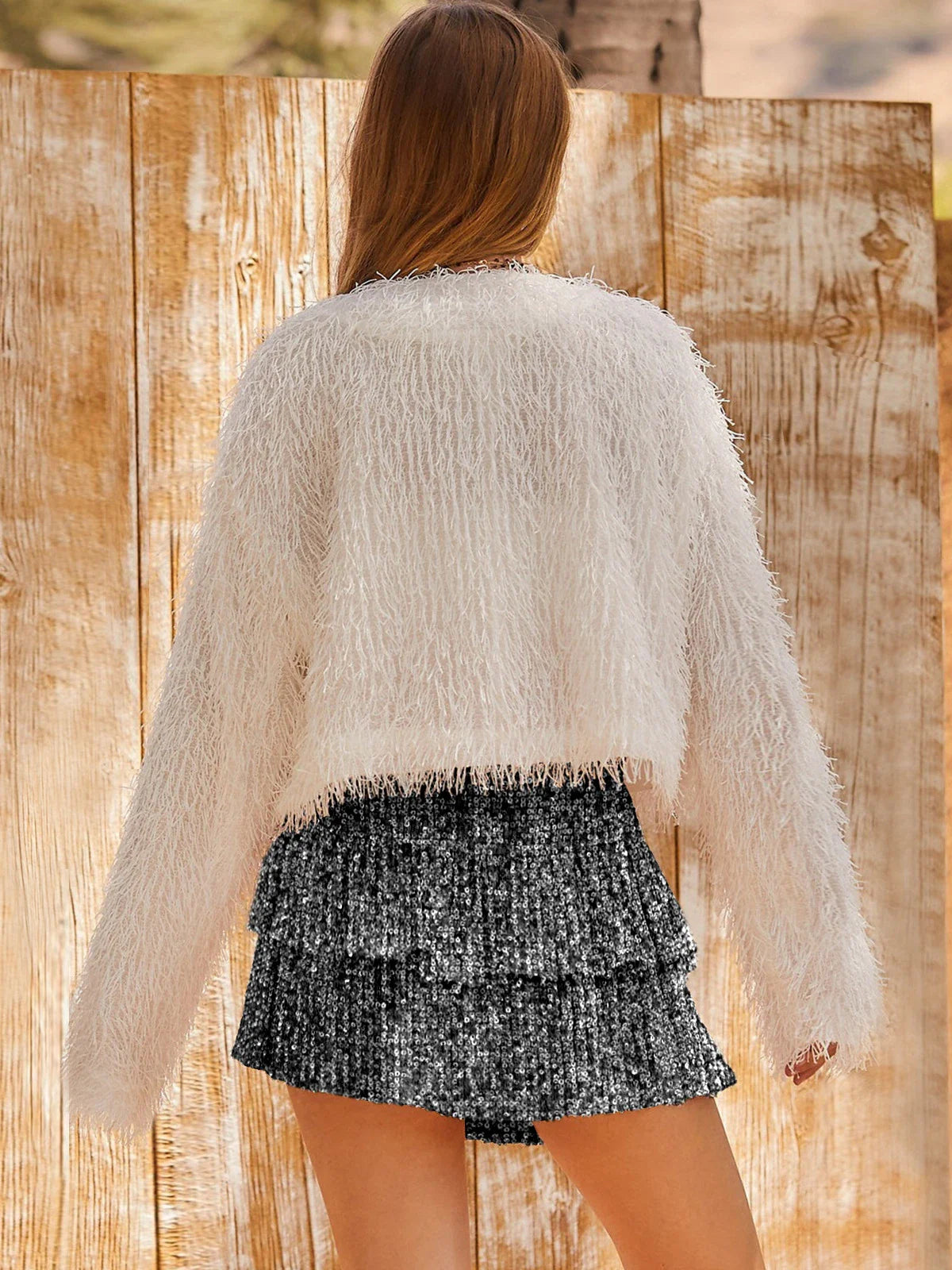 A shimmering sequin-embellished pleated skirt in a stylish rose red color, perfect for party nights and special occasions.