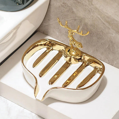 A white gold ceramic soap dish with a drainage design, showcasing a sleek and elegant bathroom accessory.
