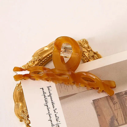 Elegant leopard print large weave hair clip for women and girls, made with durable acrylic and alloy materials for a secure and comfortable hold.