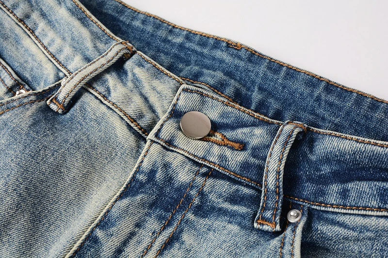 American High Street fashionable men's ripped black and white patch jeans in a light blue denim color
