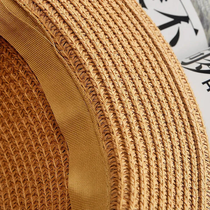 Classic straw Panama hat with a bow detail, offering sun protection and fashionable summer style