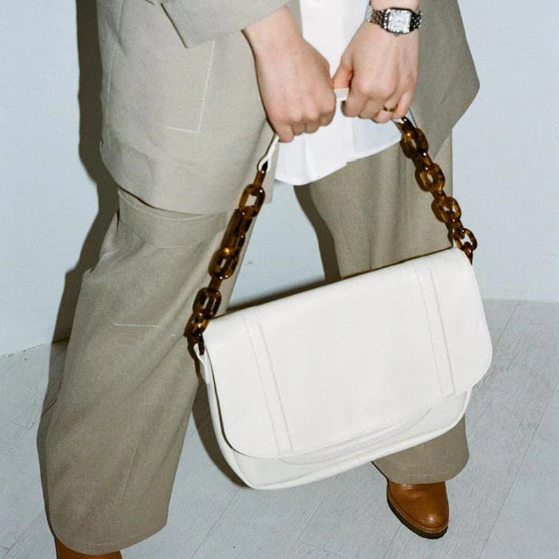 Stylish personalized acrylic chain shoulder bag in a creamywhite color, featuring a versatile tote design with a large capacity interior.
