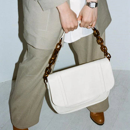Stylish personalized acrylic chain shoulder bag in a creamywhite color, featuring a versatile tote design with a large capacity interior.