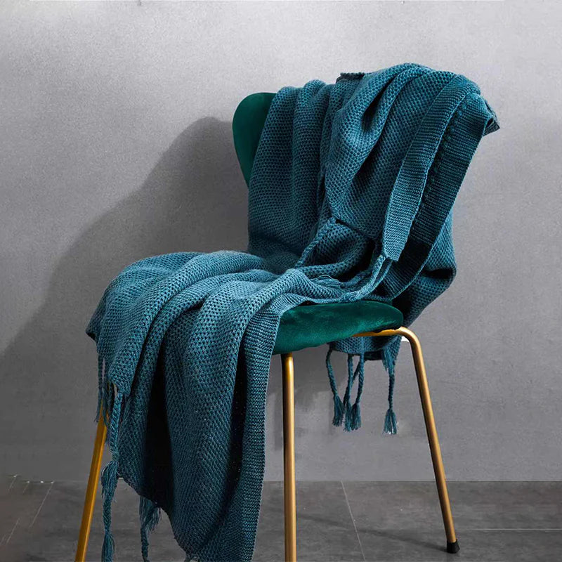 Luxurious Nordic wool knitted throw blanket with tassels in a solid gray color, a cozy and elegant home decor accessory