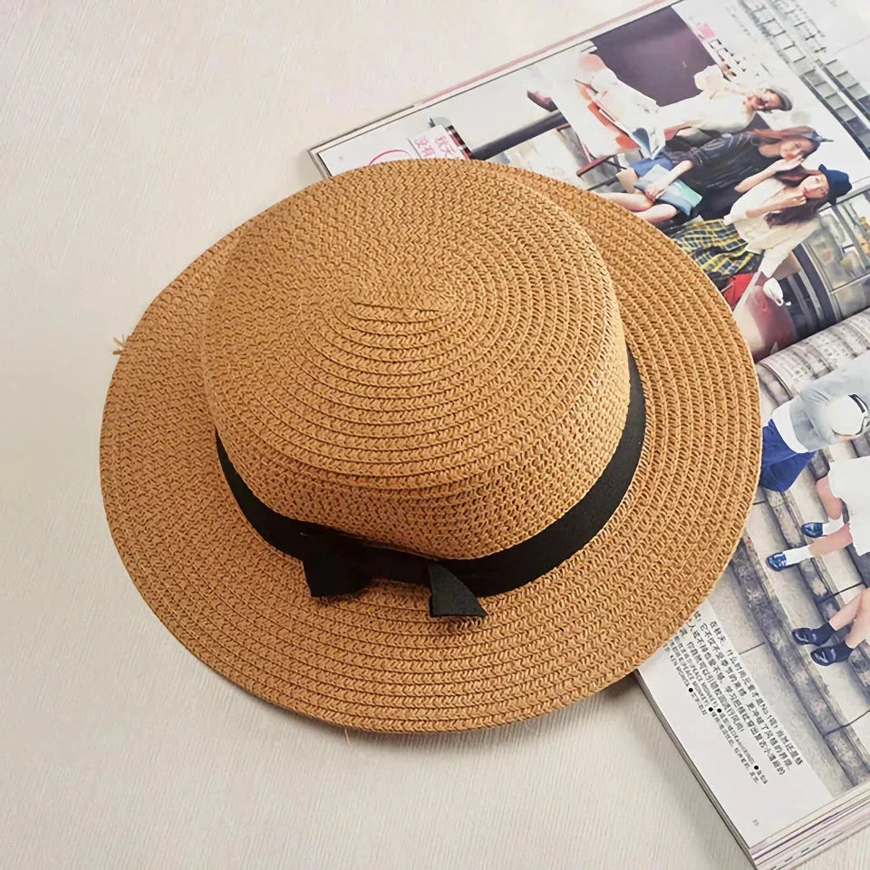 Classic straw Panama hat with a bow detail, offering sun protection and fashionable summer style