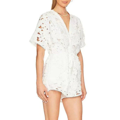 Chic embroidered hollow-out summer playsuit with a V-neck, high waistline, and short sleeves for a stylish and comfortable vacation or casual look.