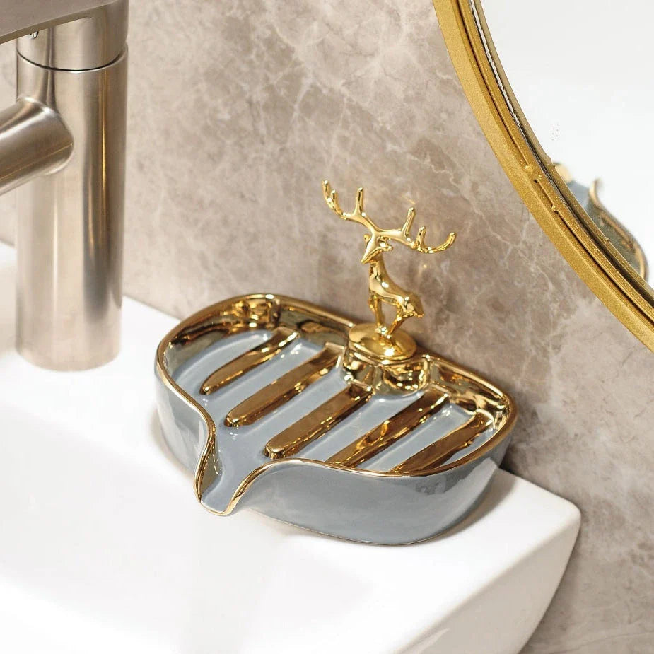 A white gold ceramic soap dish with a drainage design, showcasing a sleek and elegant bathroom accessory.