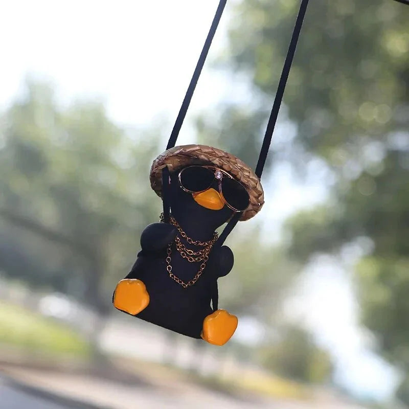Cute swinging duck car pendant with a guitar and coke-themed design, adding a touch of personality to your vehicle