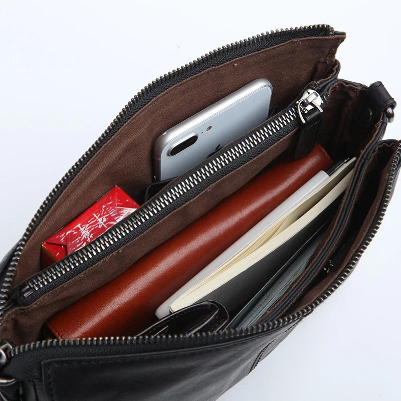Premium cowhide leather crossbody bag with multiple interior pockets for organized, hands-free carrying
