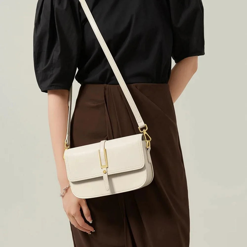 Elegant white leather crossbody bag for women with adjustable strap and multiple interior pockets for organized storage.