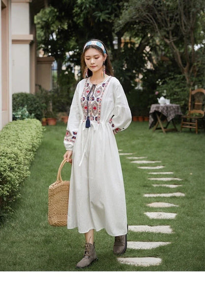Elegant embroidered cotton-linen dress with tassels, featuring a waist-cinching A-line silhouette in vibrant colors