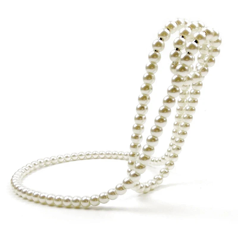 Elegant white iron wine rack with pearl necklace-inspired design, displayed on a desktop or shelf