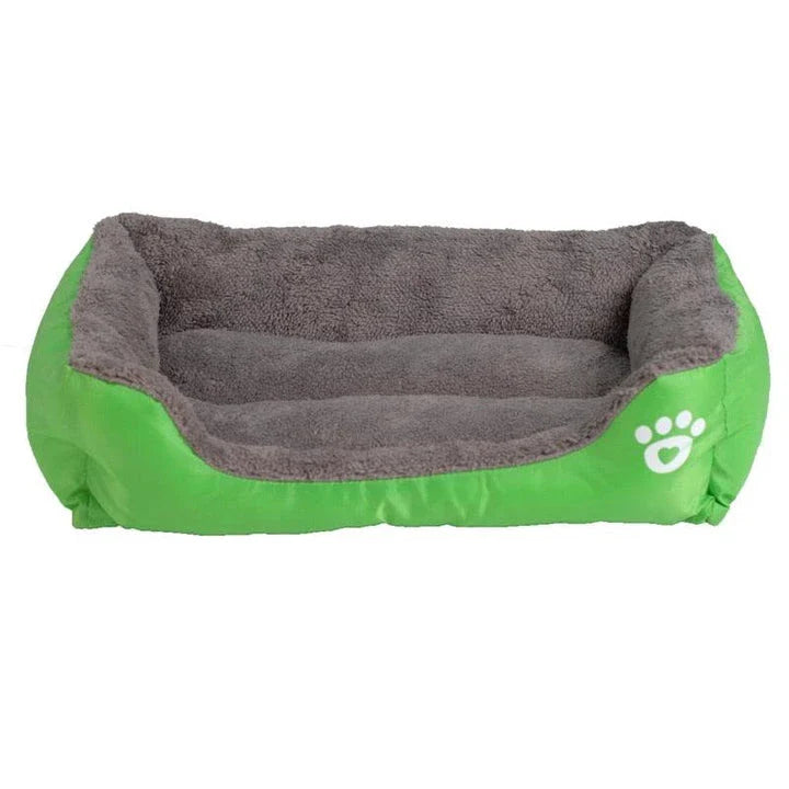 A plush, green pet bed with a paw-print pattern, designed to provide cozy and waterproof comfort for pets.
