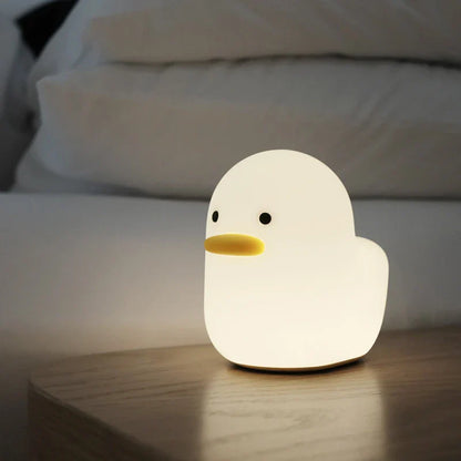 Cute duck-shaped LED night light with silicone and ABS construction, USB charging, and adjustable brightness