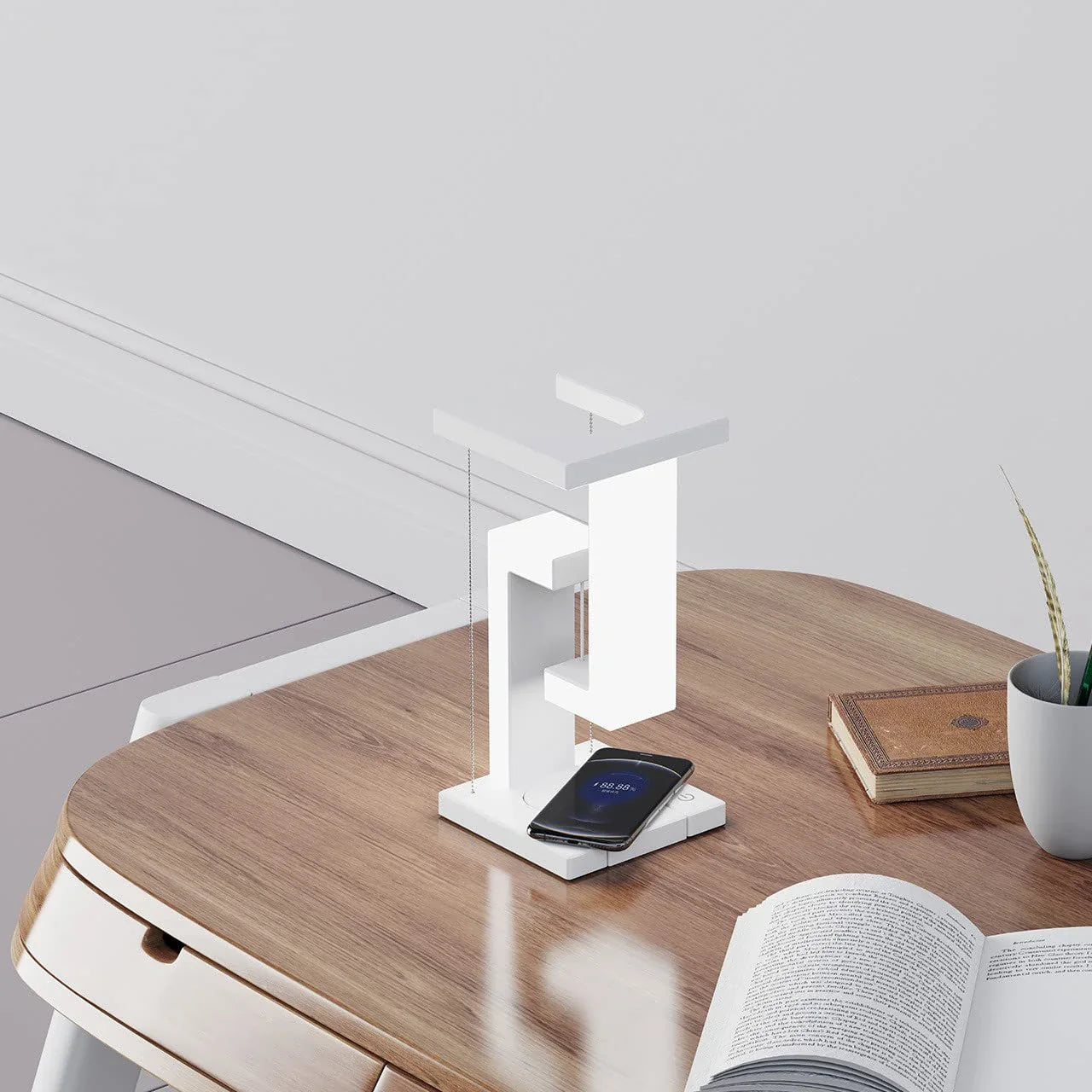 A modern, levitating desk lamp with wireless charging capabilities for smartphones