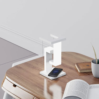A modern, levitating desk lamp with wireless charging capabilities for smartphones