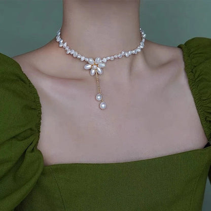 Elegant 14K gold-plated necklace with natural freshwater pearls in a unique cross-chain design