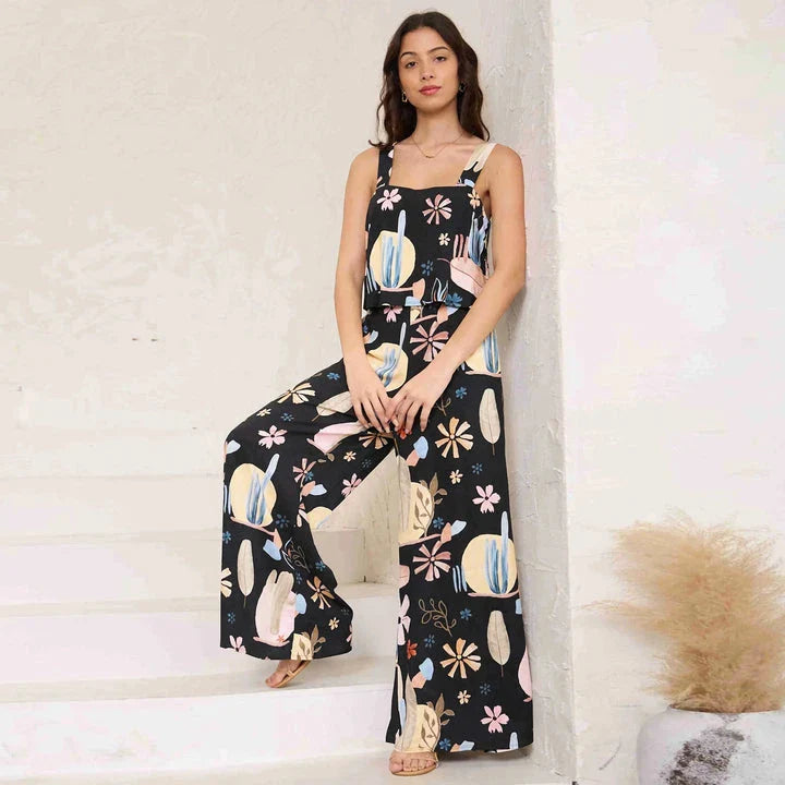 A stylish wide-leg jumpsuit with a paisley print design and a suspender top, perfect for women's casual and streetwear fashion.