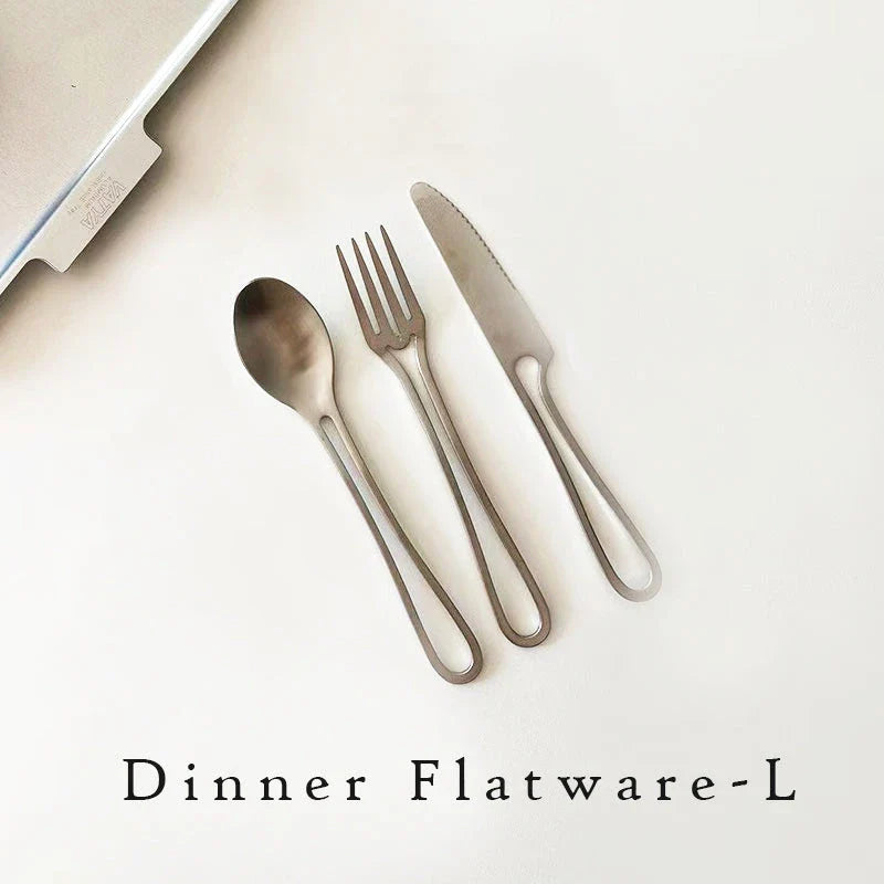 Sleek and modern 304 stainless steel cutlery set with a black finish, including knife, fork, and spoon for dinner and dessert.