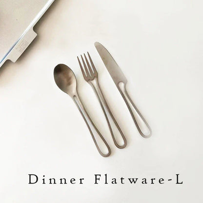 Sleek and modern 304 stainless steel cutlery set with a black finish, including knife, fork, and spoon for dinner and dessert.