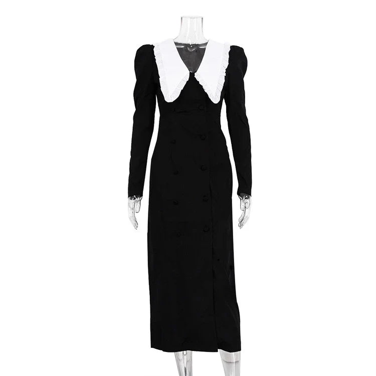 Black and white color-blocked dress with long sleeves and a doll collar, showcasing a timeless and sophisticated style.