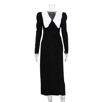 Black and white color-blocked dress with long sleeves and a doll collar, showcasing a timeless and sophisticated style.