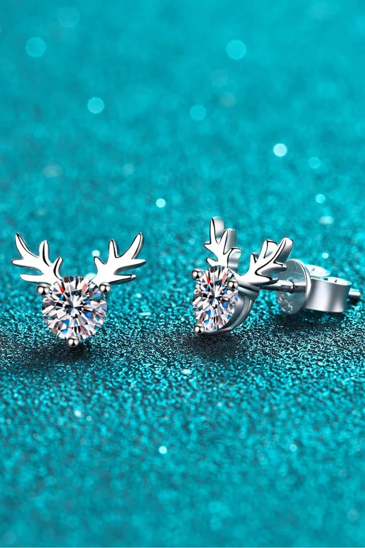 A modern, minimalist ring in sterling silver featuring a reindeer-inspired design with a sparkling moissanite stone.