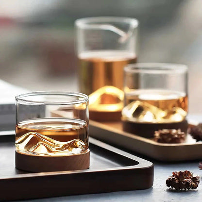 Elegant mountain-inspired whiskey glass with a wooden base, perfect for enjoying a variety of hot and cold beverages