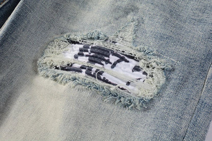 American High Street fashionable men's ripped black and white patch jeans in a light blue denim color