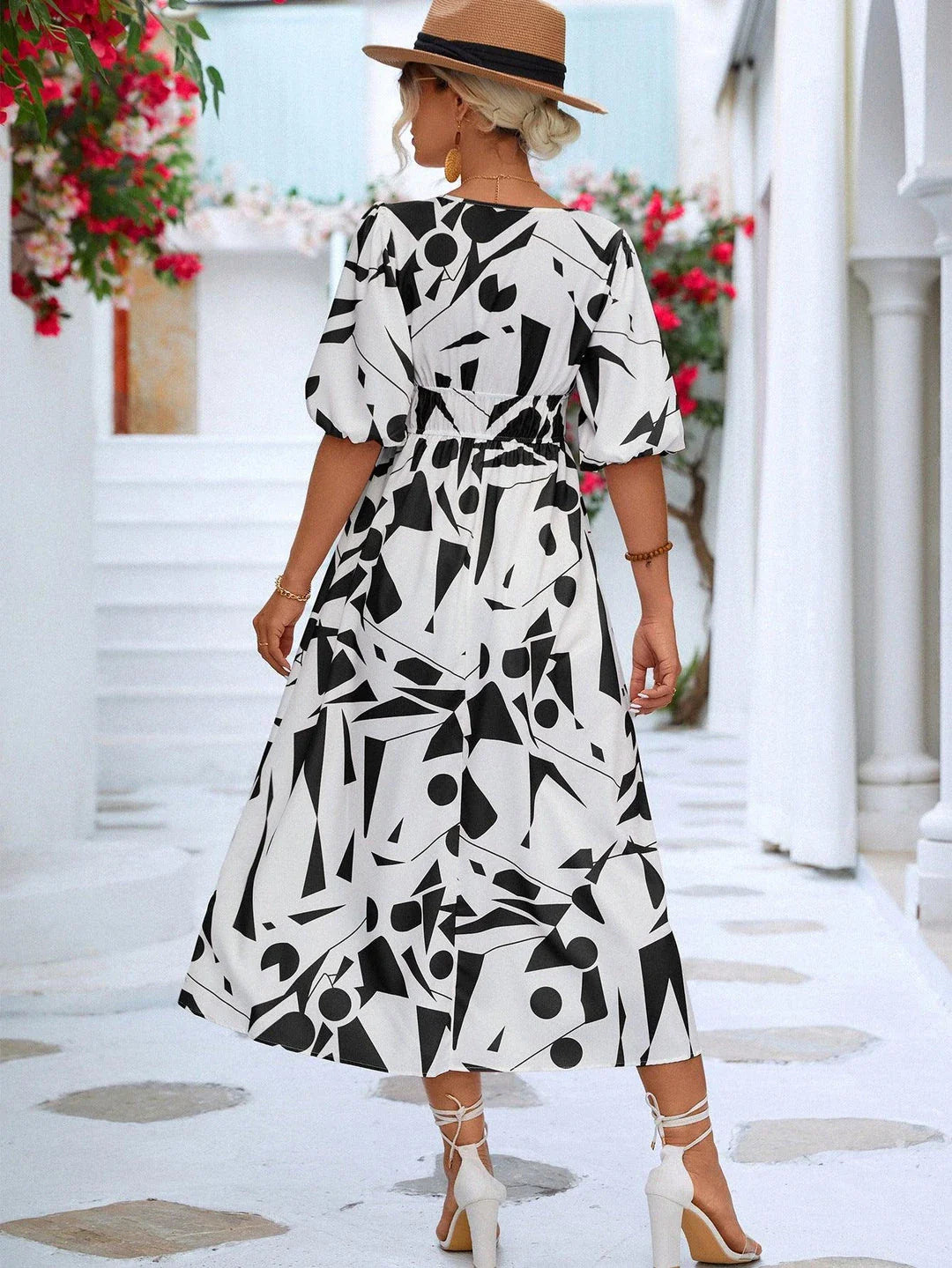 A stylish printed surplice dress with balloon sleeves, perfect for effortless elegance