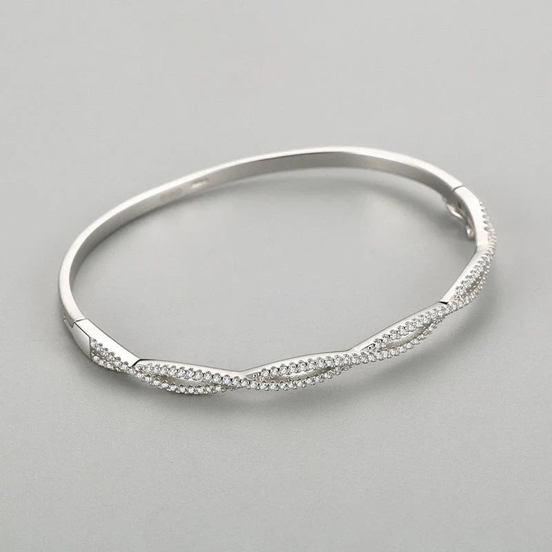 Elegant silver bracelet with a captivating wave-like design, a premium micro-set jewelry piece crafted with superior Seiko technology